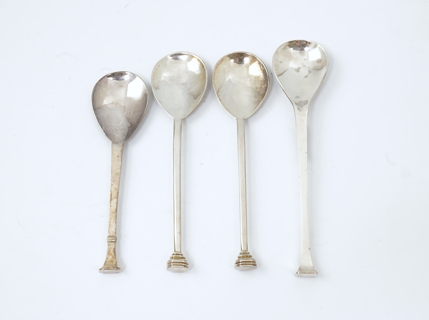 A pair of Elizabeth II silver 'seal top' spoons by The Guild of Handicrafts, London, 1990, 16cm, together with a similar later spoon, London, 2008 and a similar preserve spoon, London, 2003, two with boxes.